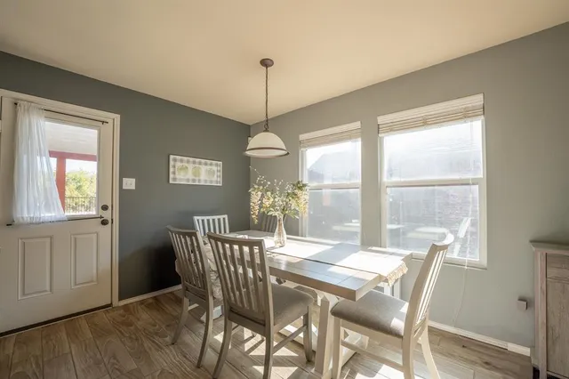 a view of a dining room with furniture window and wooden floor