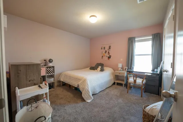 a bedroom with a bed and a view of chair