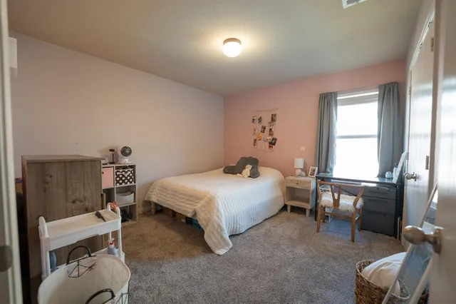 a bedroom with a bed and a view of chair