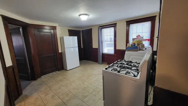 a view of room with furniture and refrigerator