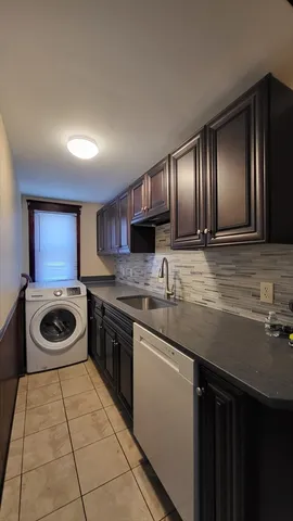 a kitchen with a stove sink and cabinets