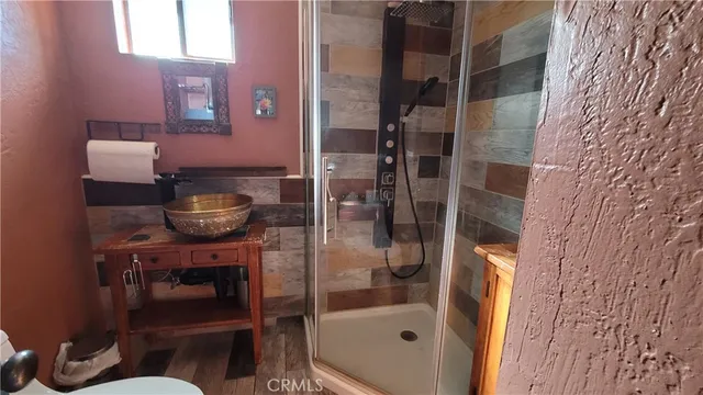 a bathroom with a granite countertop shower and a sink
