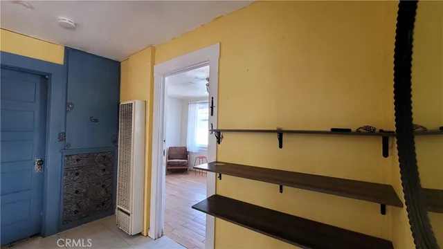 a kitchen with a table chairs and refrigerator