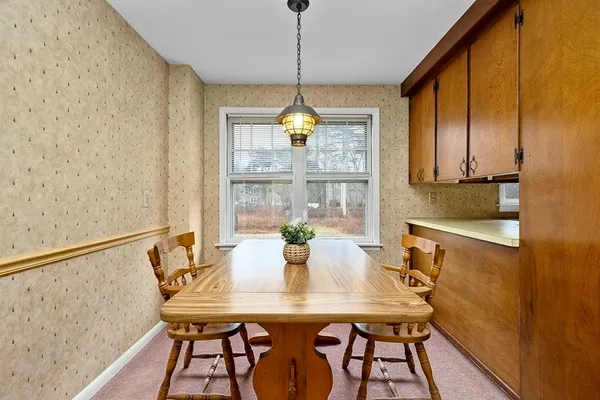 a kitchen with a table chairs and cabinets