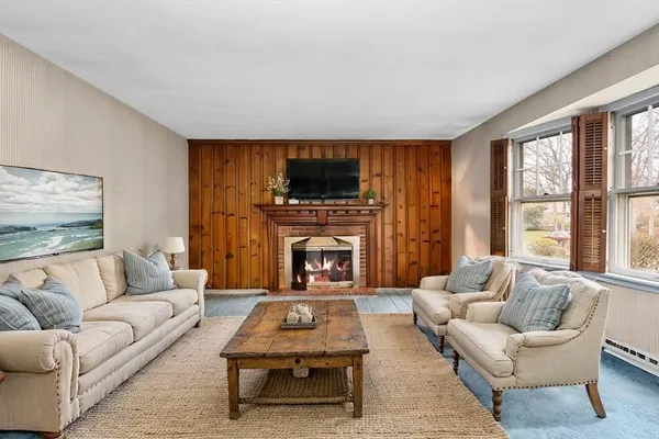 a living room with furniture a flat screen tv and a fireplace