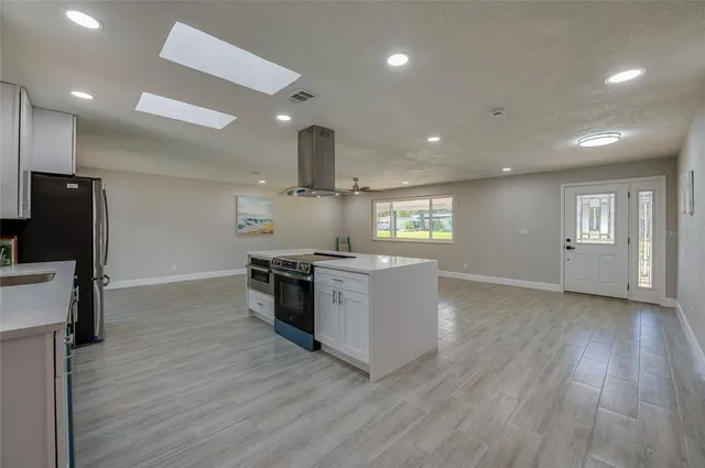 a kitchen with a refrigerator sink and cabinets