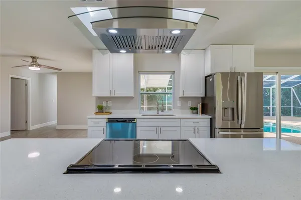 a kitchen with a stove and a wooden floor