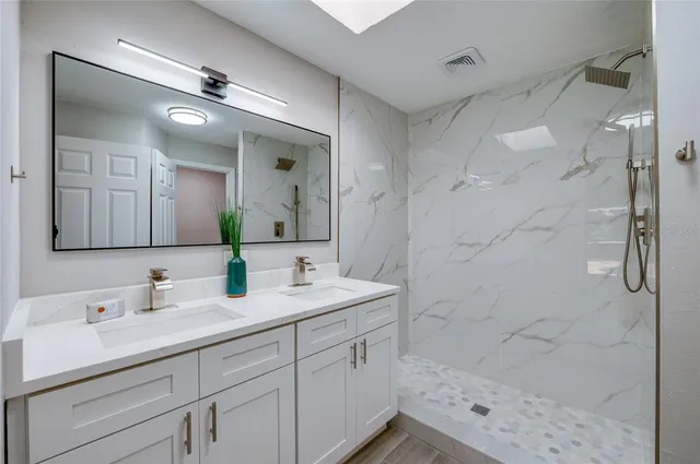 an empty room with wooden floor and ceiling fan