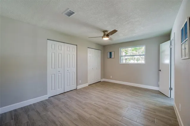 a spacious bathroom with a double vanity sink and mirror