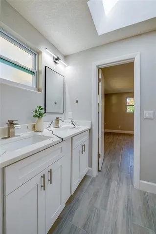an empty room with wooden floor and ceiling fan