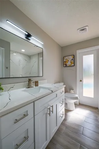 a view of a house with backyard sitting area and tub