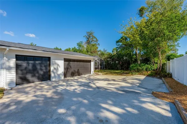 a view of a house with a yard and garage