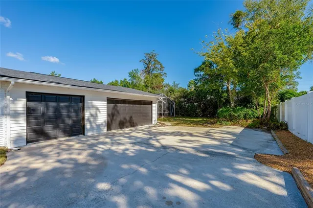 a view of a house with a yard and garage