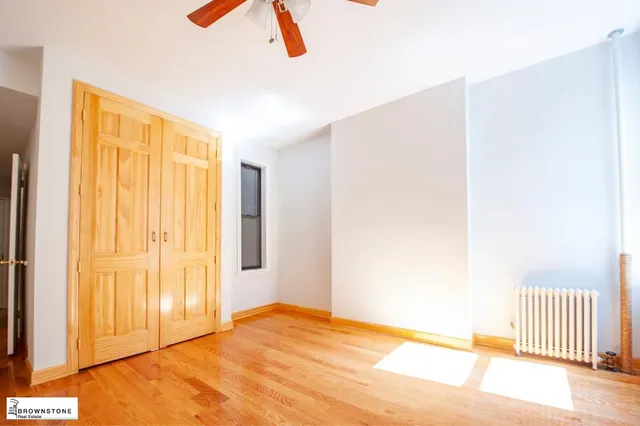 a kitchen with white cabinets and appliances