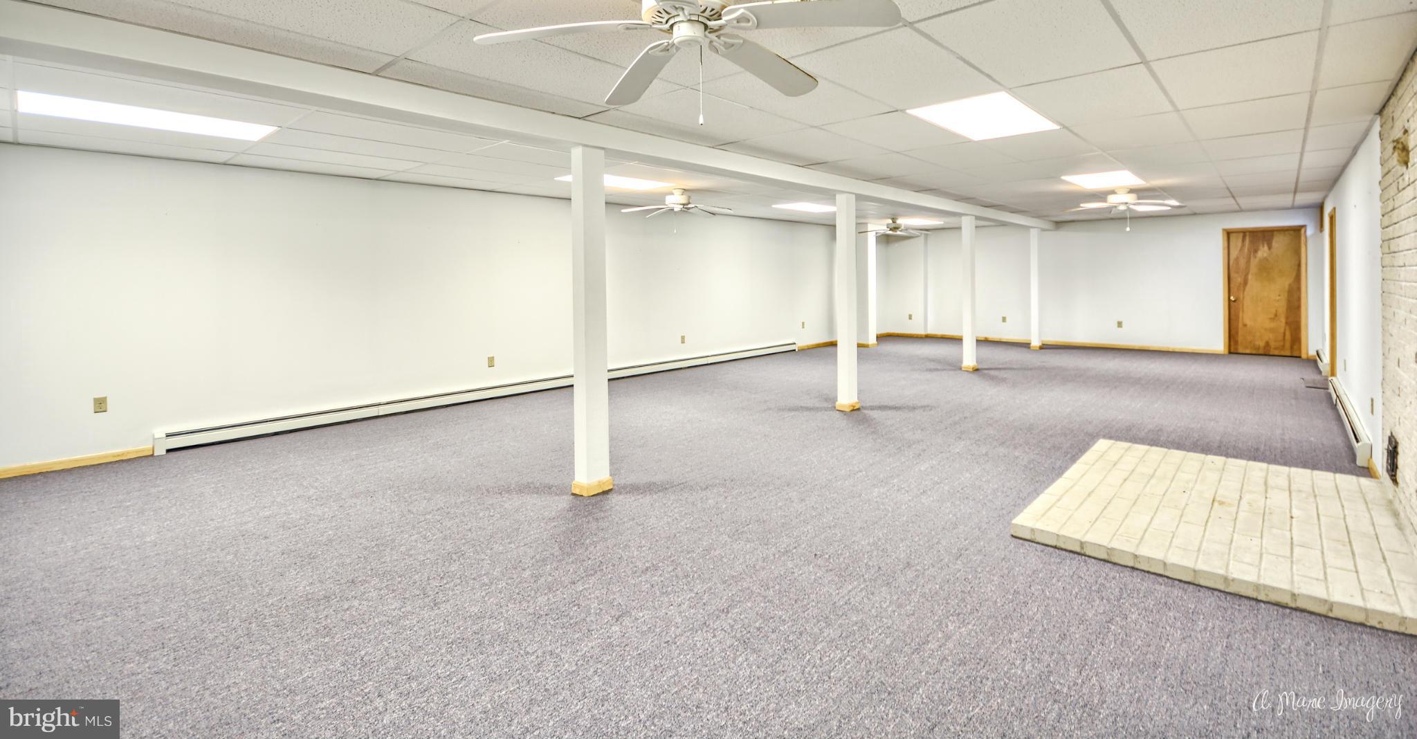8021 Rocky Springs Road Frederick, MD 21702 - Photo 21 of 30 an empty room with a ceiling fan and windows
