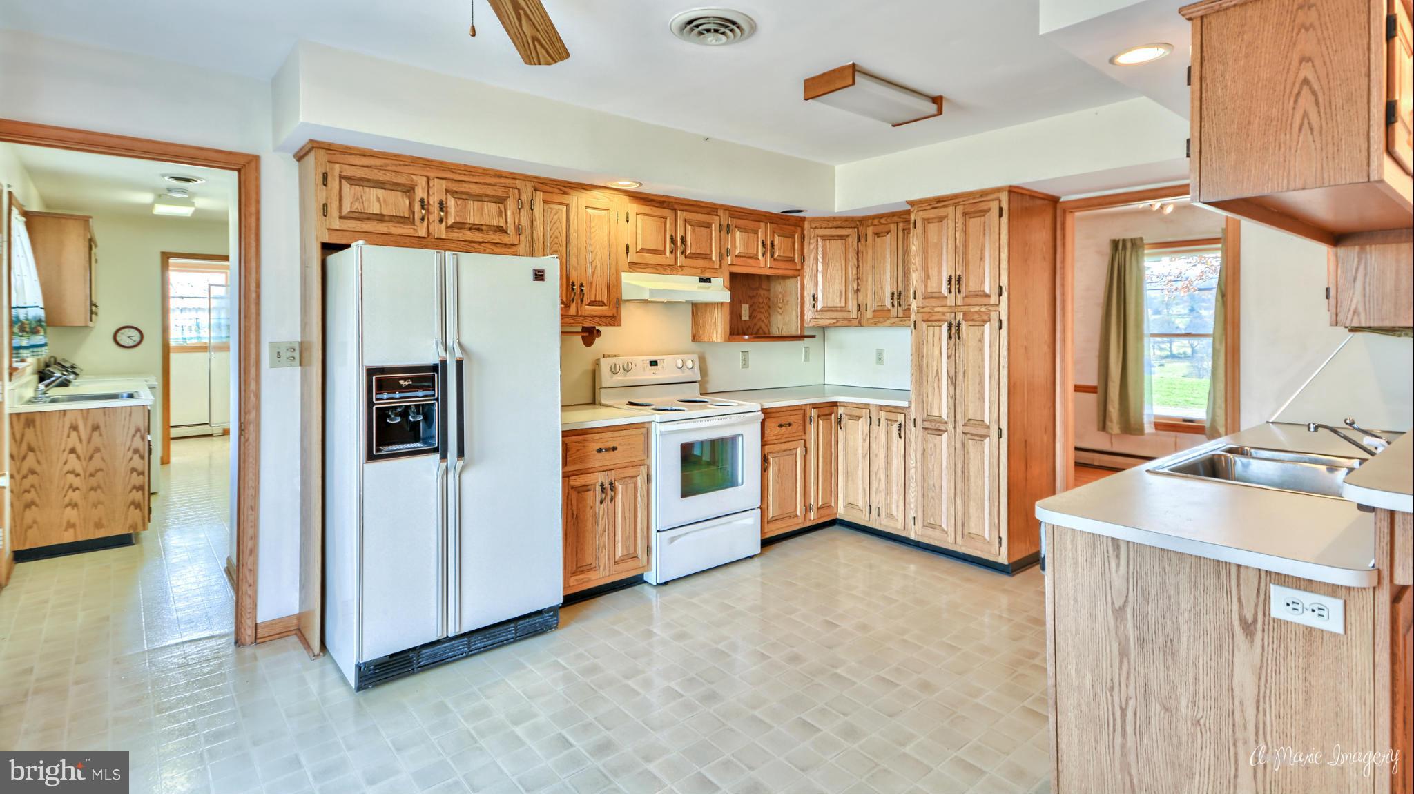 8021 Rocky Springs Road Frederick, MD 21702 - Photo 5 of 30 a kitchen with stainless steel appliances a refrigerator sink and cabinets