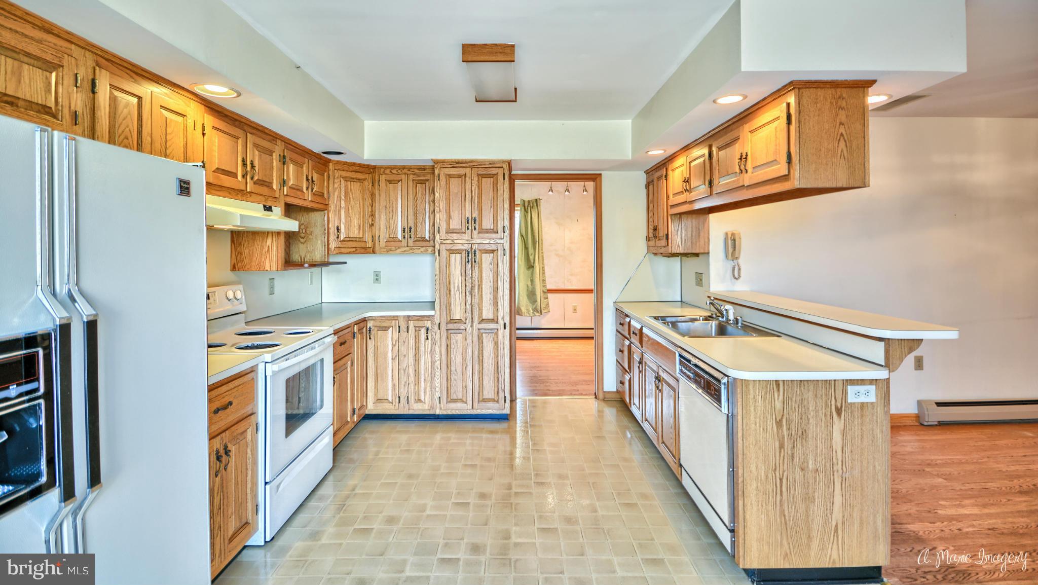 8021 Rocky Springs Road Frederick, MD 21702 - Photo 6 of 30 a kitchen with a stove a refrigerator and a sink