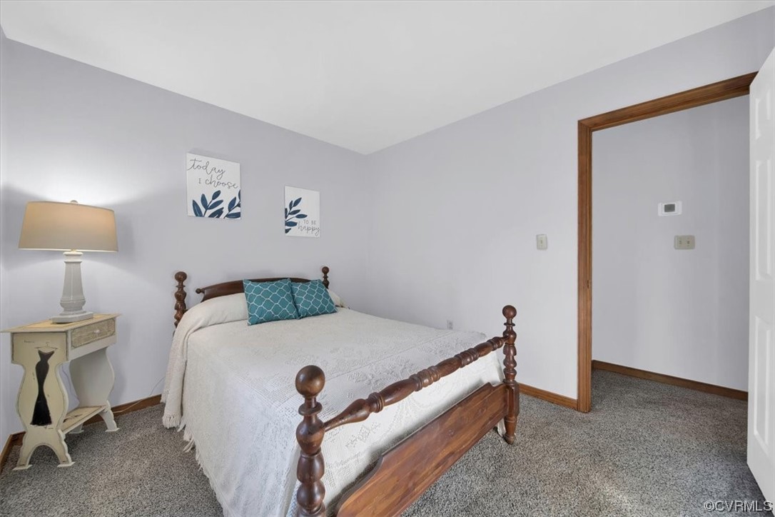 3350 Forest Grove Road Sandy Hook, VA 23153 - Photo 24 of 42 a bedroom with a bed and a table in it