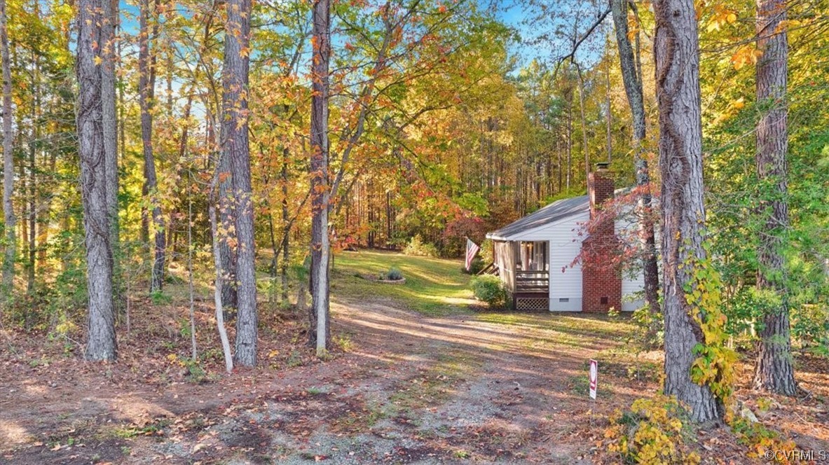 3350 Forest Grove Road Sandy Hook, VA 23153 - Photo 36 of 42 a view of a house with a large tree and a yard