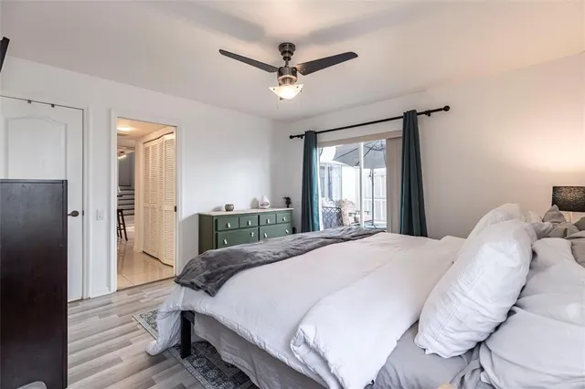 a bedroom with a large bed and a chandelier