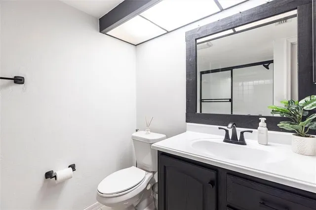 a bathroom with a sink a toilet and mirror