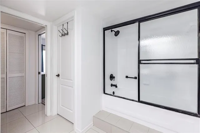 a bathroom with a glass shower door