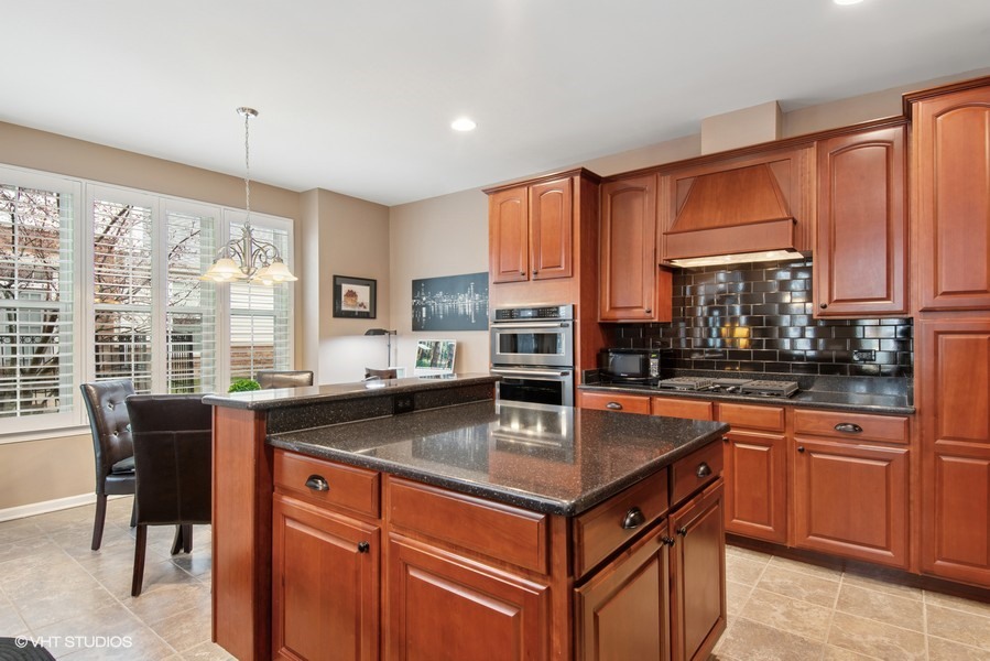 2846 Normandy Circle Naperville, IL 60564 - Photo 7 of 44 a kitchen with stainless steel appliances granite countertop a sink a stove and a refrigerator