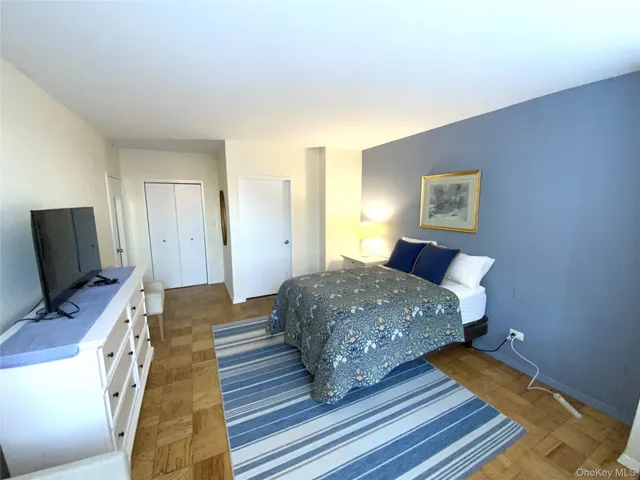 a bedroom with a bed and flat screen tv