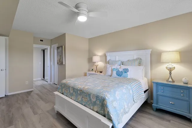 a bedroom with a bed and a lamp on dresser