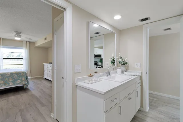 a bathroom with a double vanity sink and a mirror