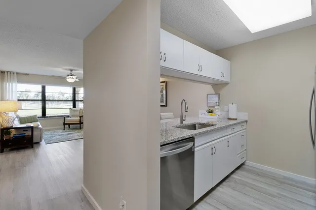 a kitchen with a sink and a stove top oven