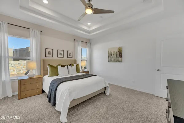 a spacious bedroom with a bed and a window