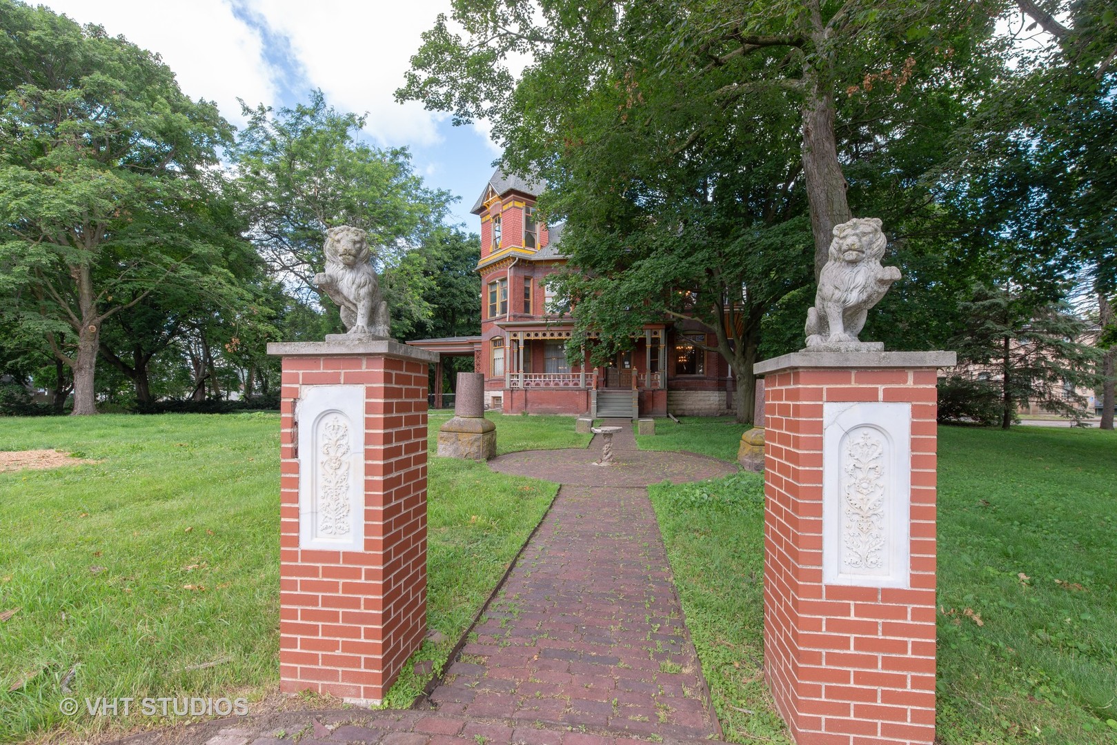 307 North Main Street Sycamore, IL 60178 - Photo 2 of 32 a view of a back yard with flower plants and large trees