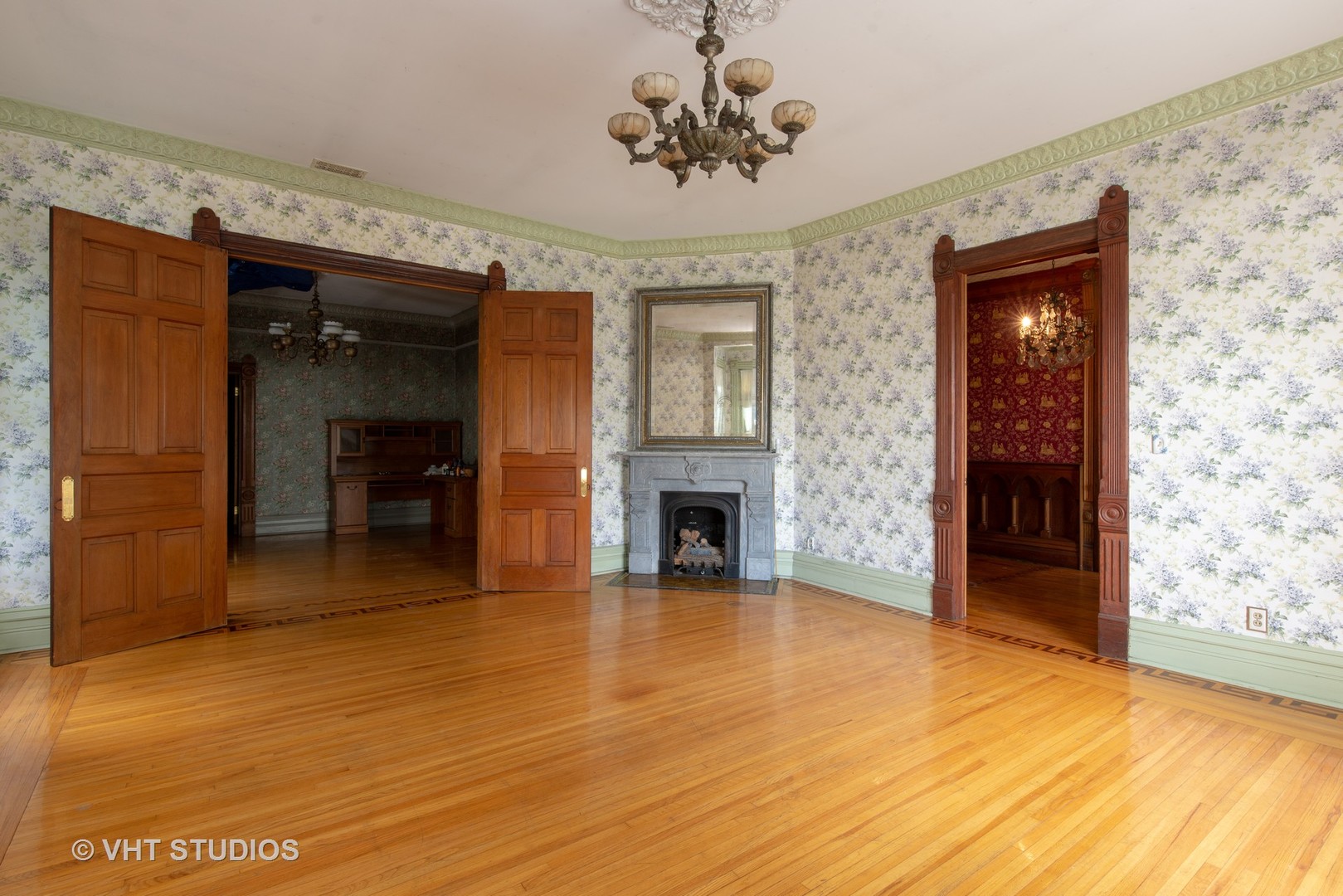 307 North Main Street Sycamore, IL 60178 - Photo 25 of 32 a view of a livingroom with a fireplace a chandelier and stairs