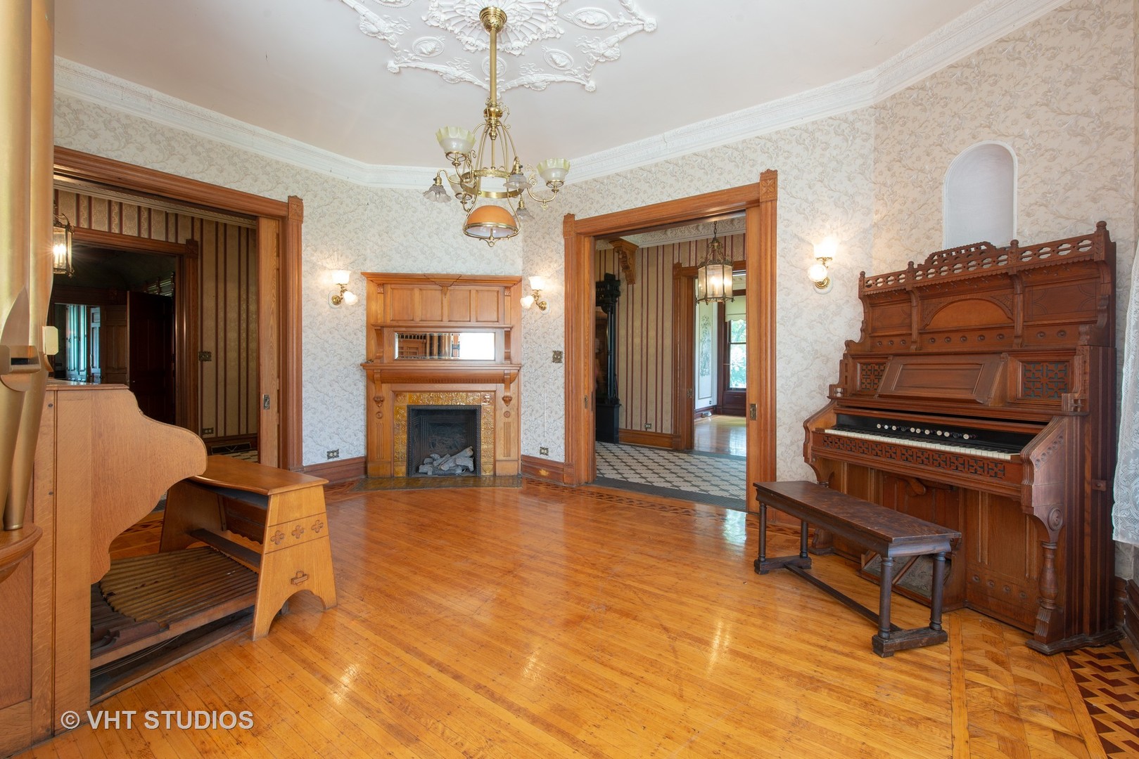 307 North Main Street Sycamore, IL 60178 - Photo 9 of 32 a living room with furniture a fireplace and a chandelier