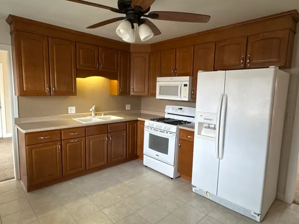 a kitchen with stainless steel appliances a refrigerator sink and microwave