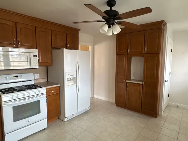 a kitchen with stainless steel appliances a refrigerator and a stove top oven