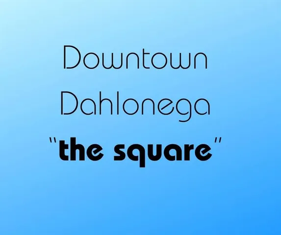 a view of a building with retail shops and traffic signal