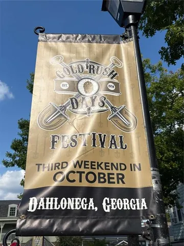 a front view of a house with yard and a pond