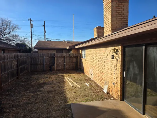a view of a backyard with sitting area