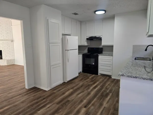 a kitchen with kitchen island a sink stainless steel appliances and cabinets