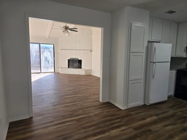 a view of a kitchen with a white cabinet and a refrigerator
