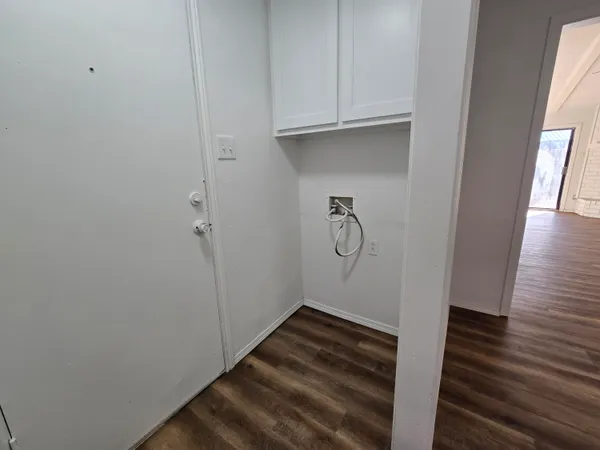 a view of a room with wooden floor