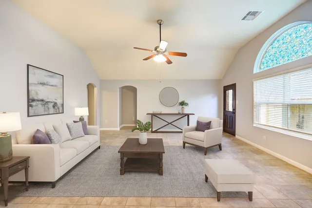 a living room with furniture chandelier and a large window