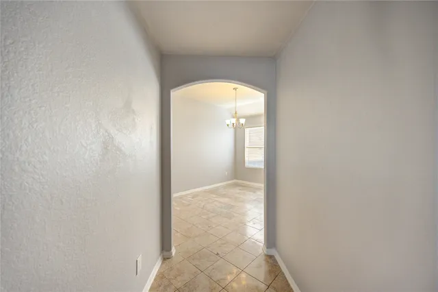 a view of a hallway with a glass door and a window