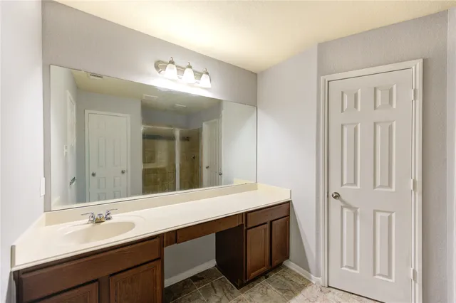 a bathroom with a double vanity sink and a mirror