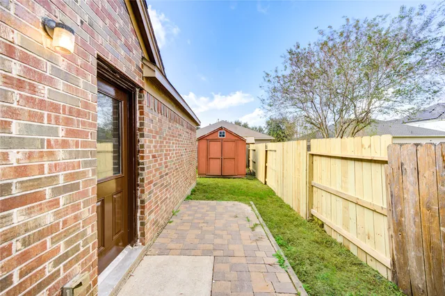 a view of a pathway of a house with a yard