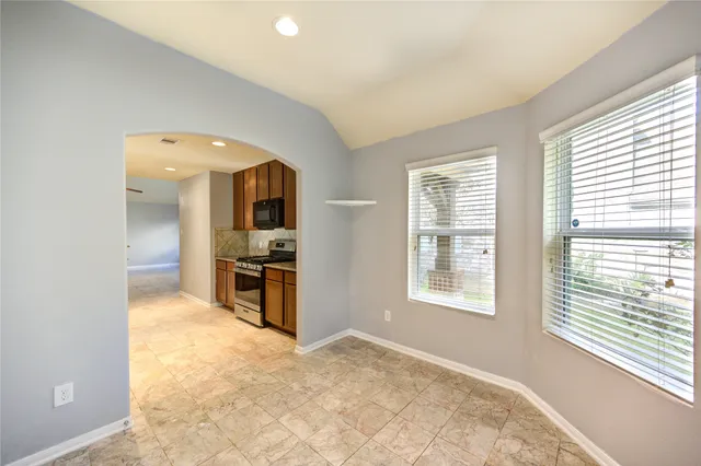 a view of a kitchen with a sink and a window