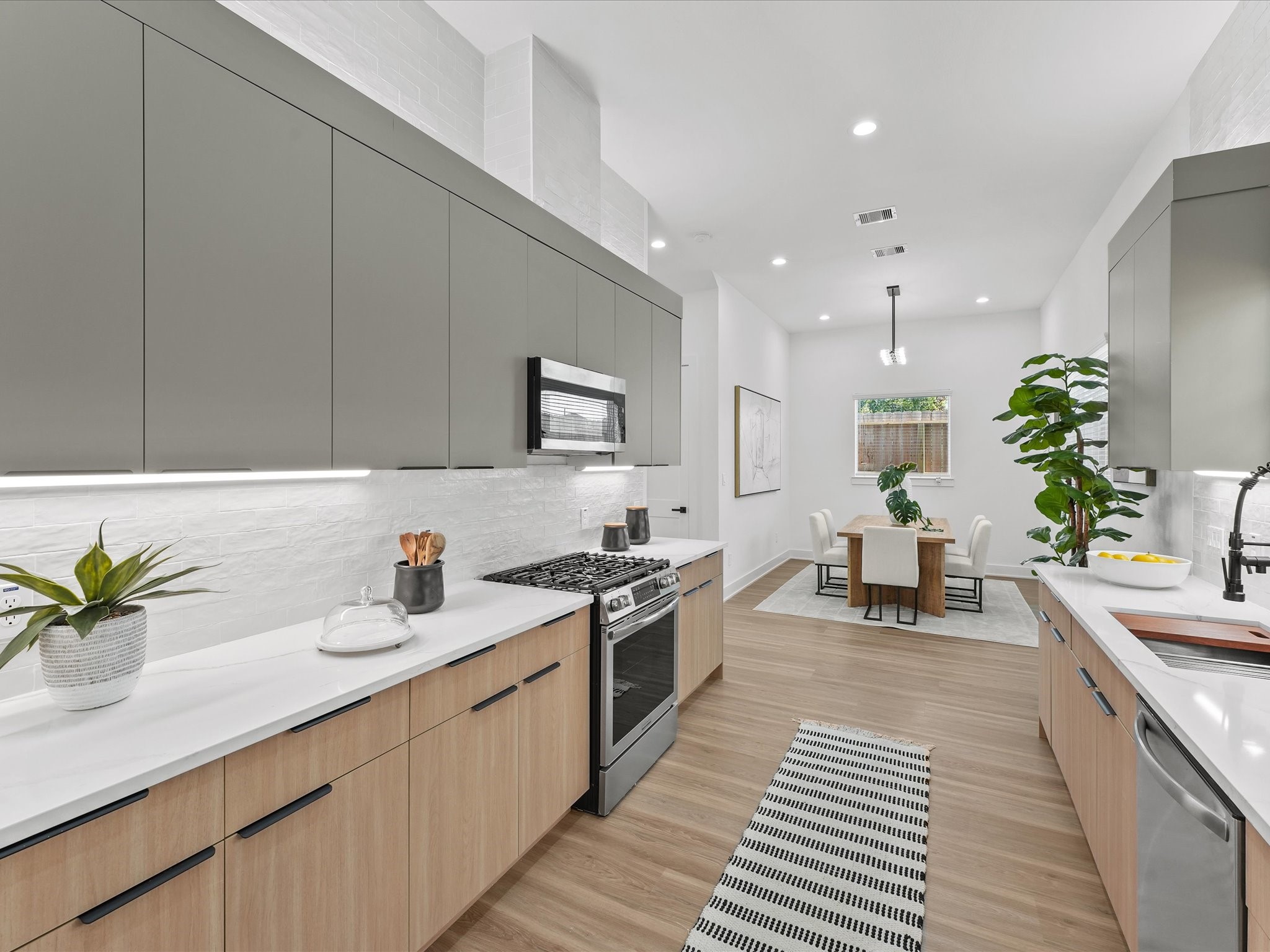 a kitchen with a sink and stove top oven