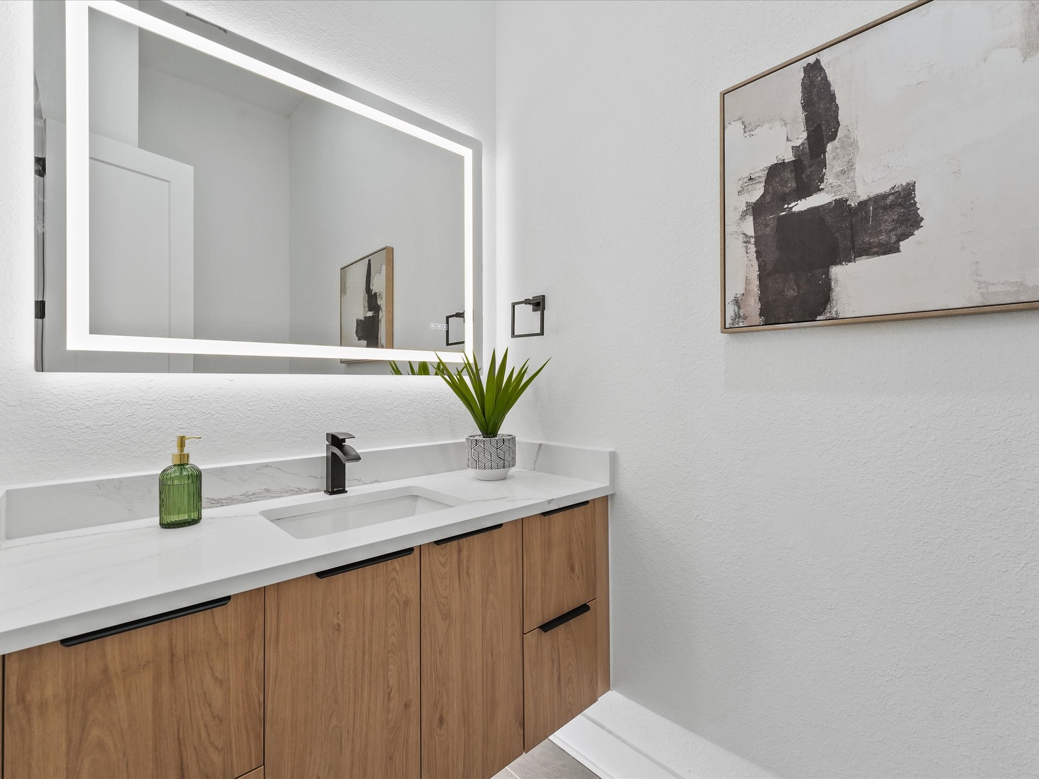 2592 West Tidwell Road Houston, TX 77091 - Photo 20 of 25 a bathroom with a granite countertop sink a mirror and vanity